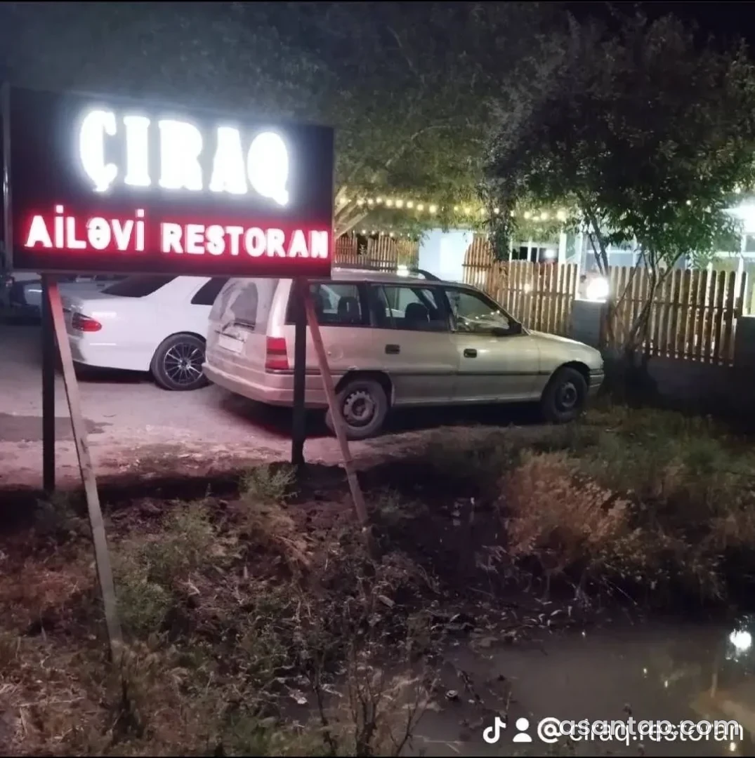 Çıraq Ailəvi Restoranın işıqlı lövhəsi və ağaclı həyətinin girişi — sentyabr2023 arxiv fotosu