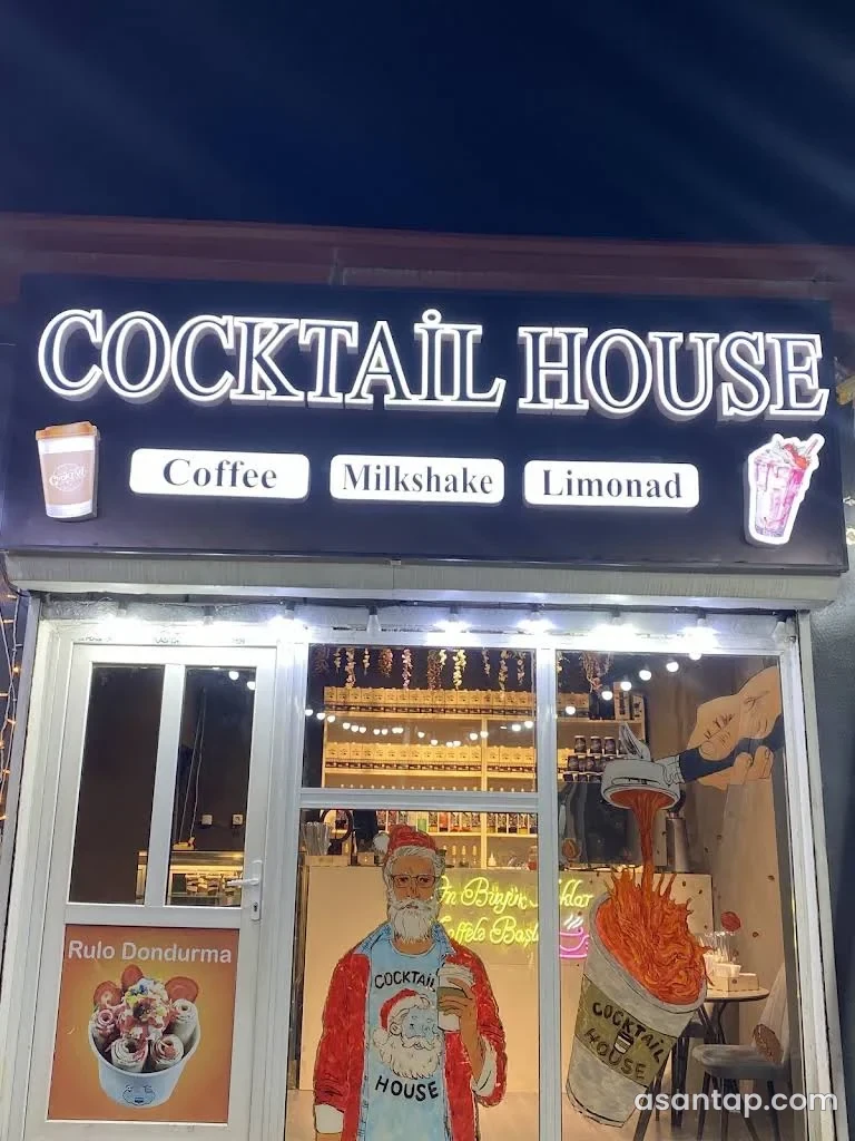 Cocktail House-un işıqlı yazısı, şüşə vitrini, içki şüşələri olan rəfi və fincan təsvirli divarı