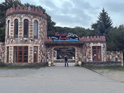 Narzan Bulağı restoranının iki yumru qülləli, rəngli daş naxışlı və yazılı giriş fasadı
